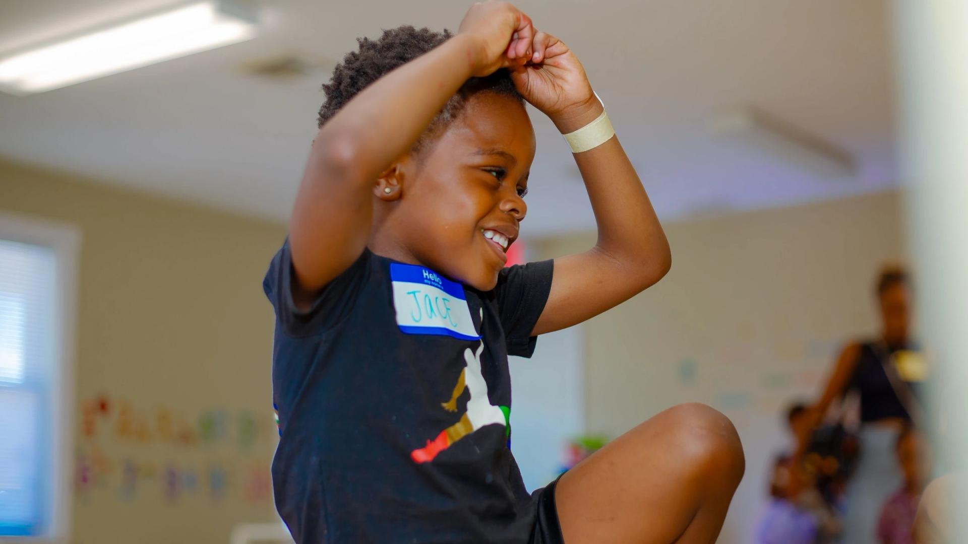 A joyful child engaged in classroom activity