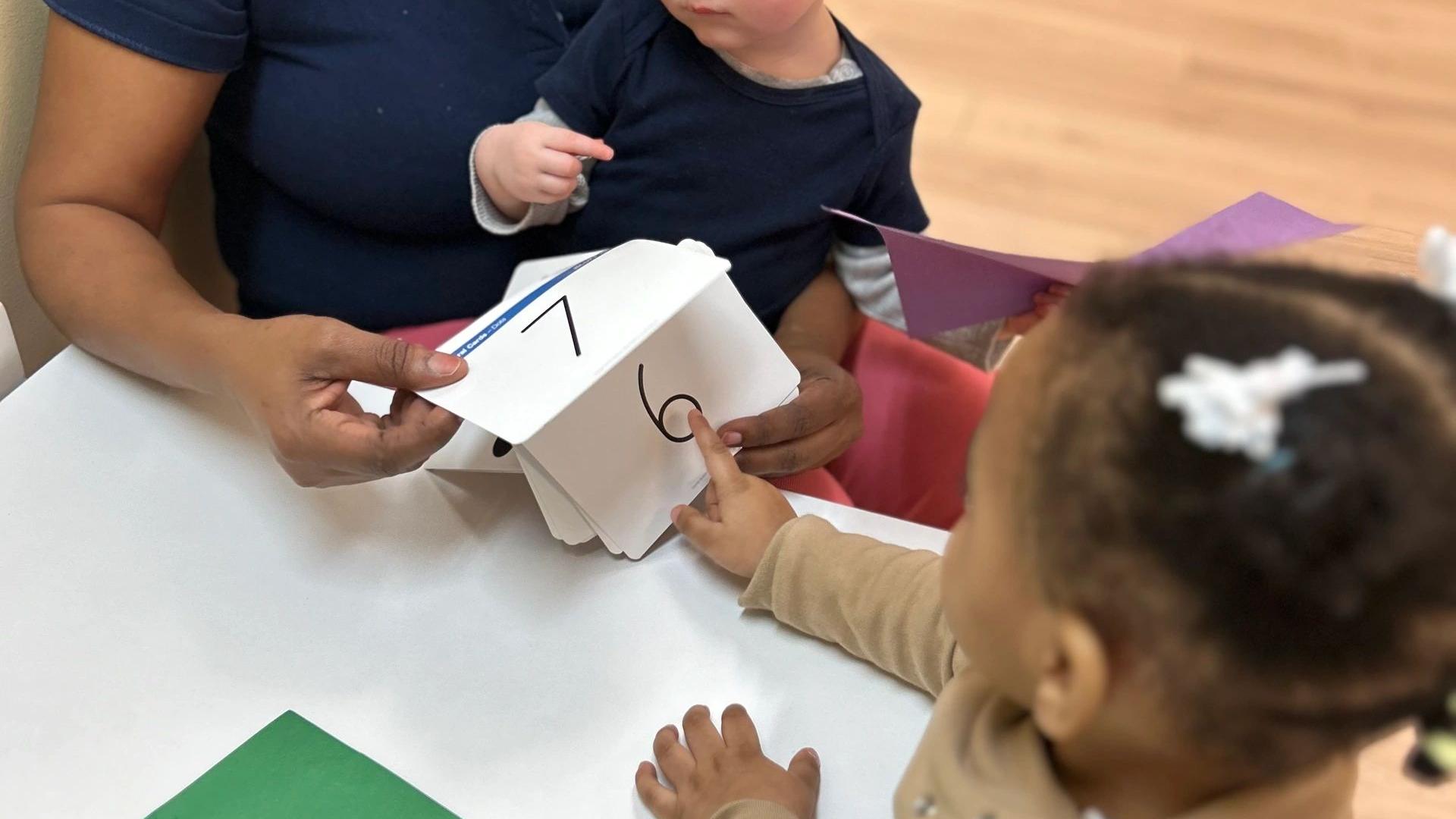 A teacher learning with toddlers at La Distinction Academy