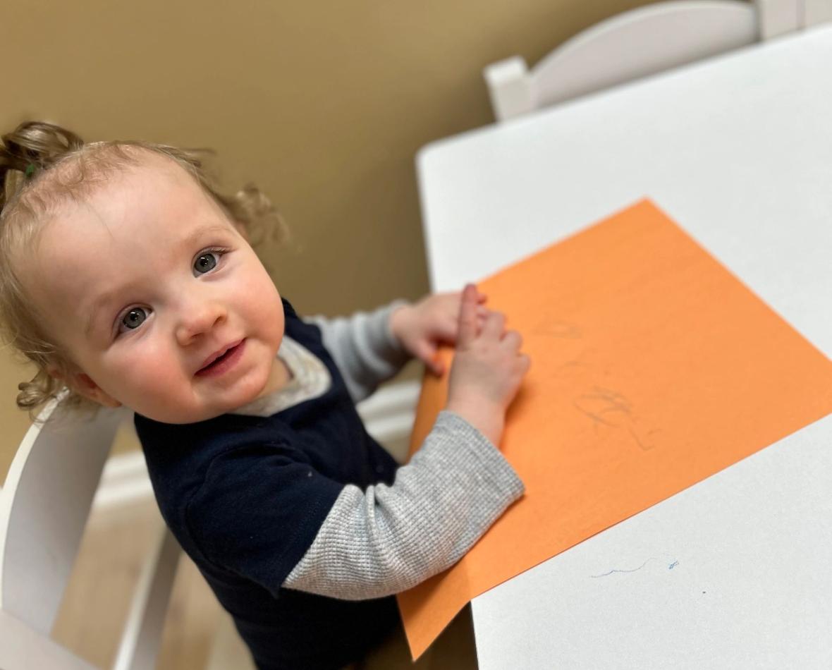 A smiling toddler at the academy