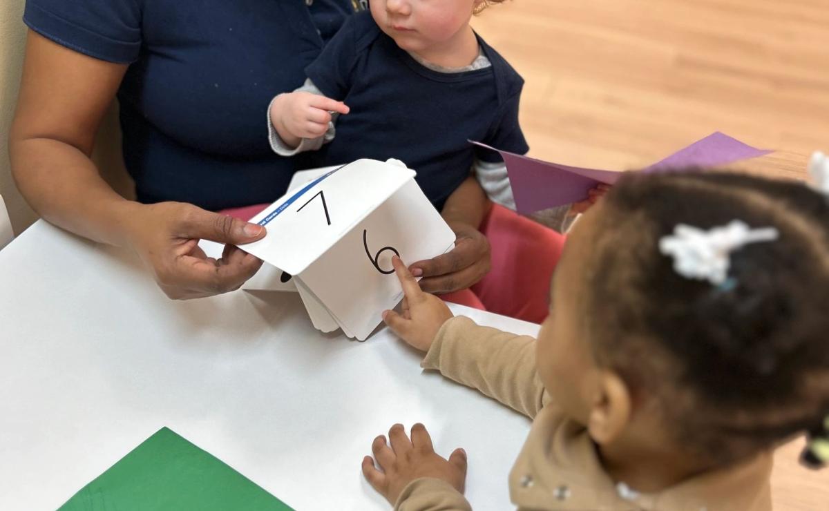 A teacher learning with toddlers at La Distinction Academy