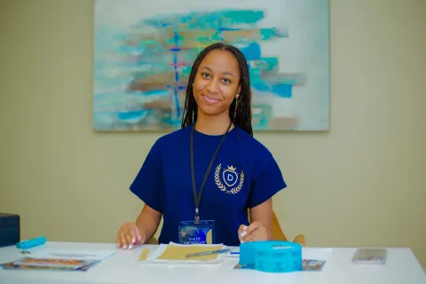 A welcoming educator at the front desk