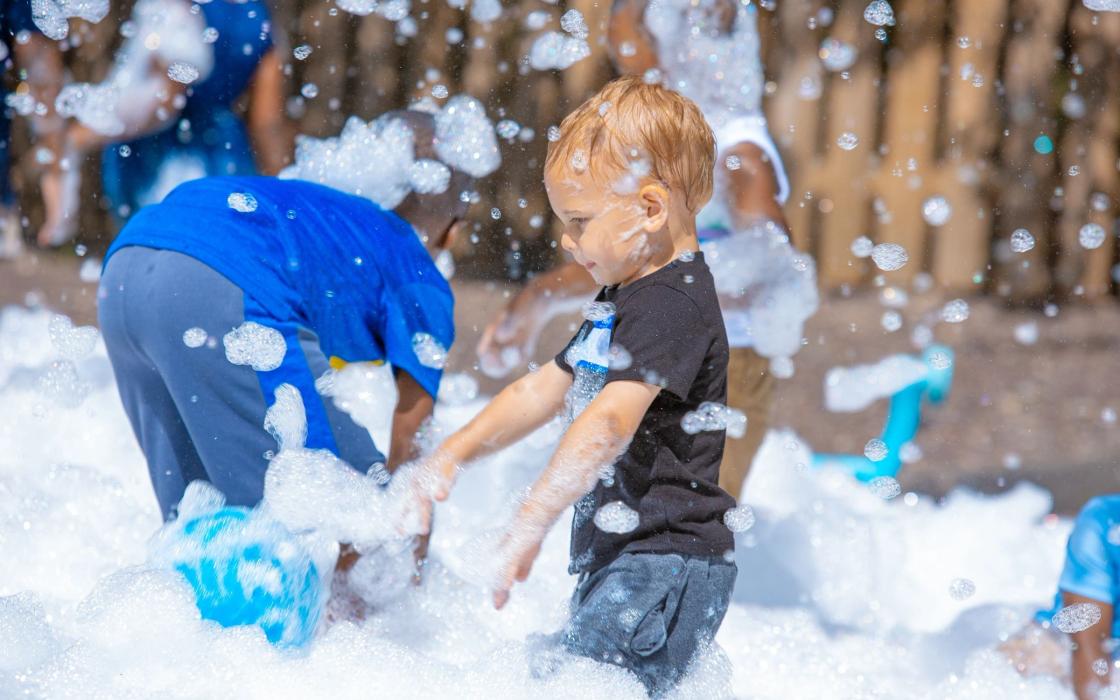 A child playing in foam at a family event