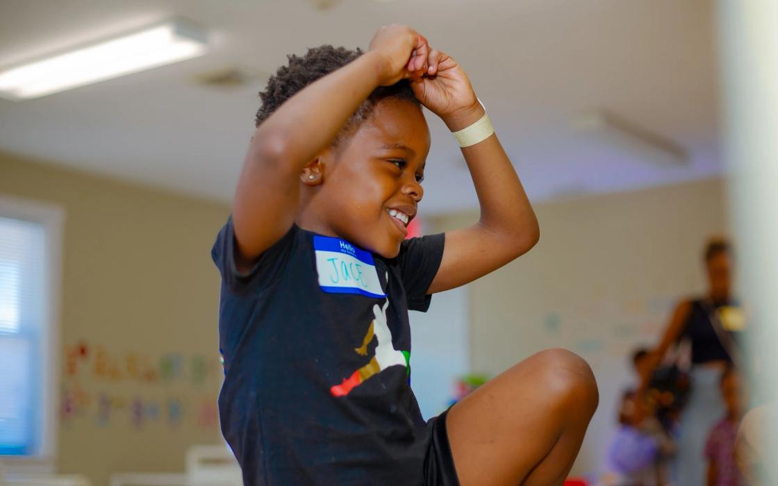 A joyful child engaged in classroom activity