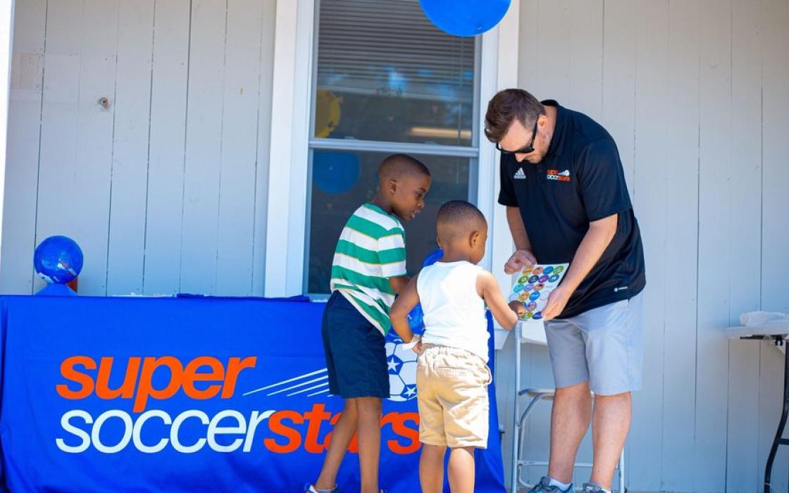 Children meeting a coach at a Super Soccer Stars visit
