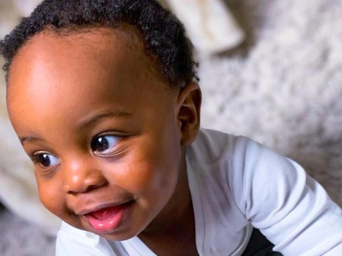 A smiling baby crawling and exploring
