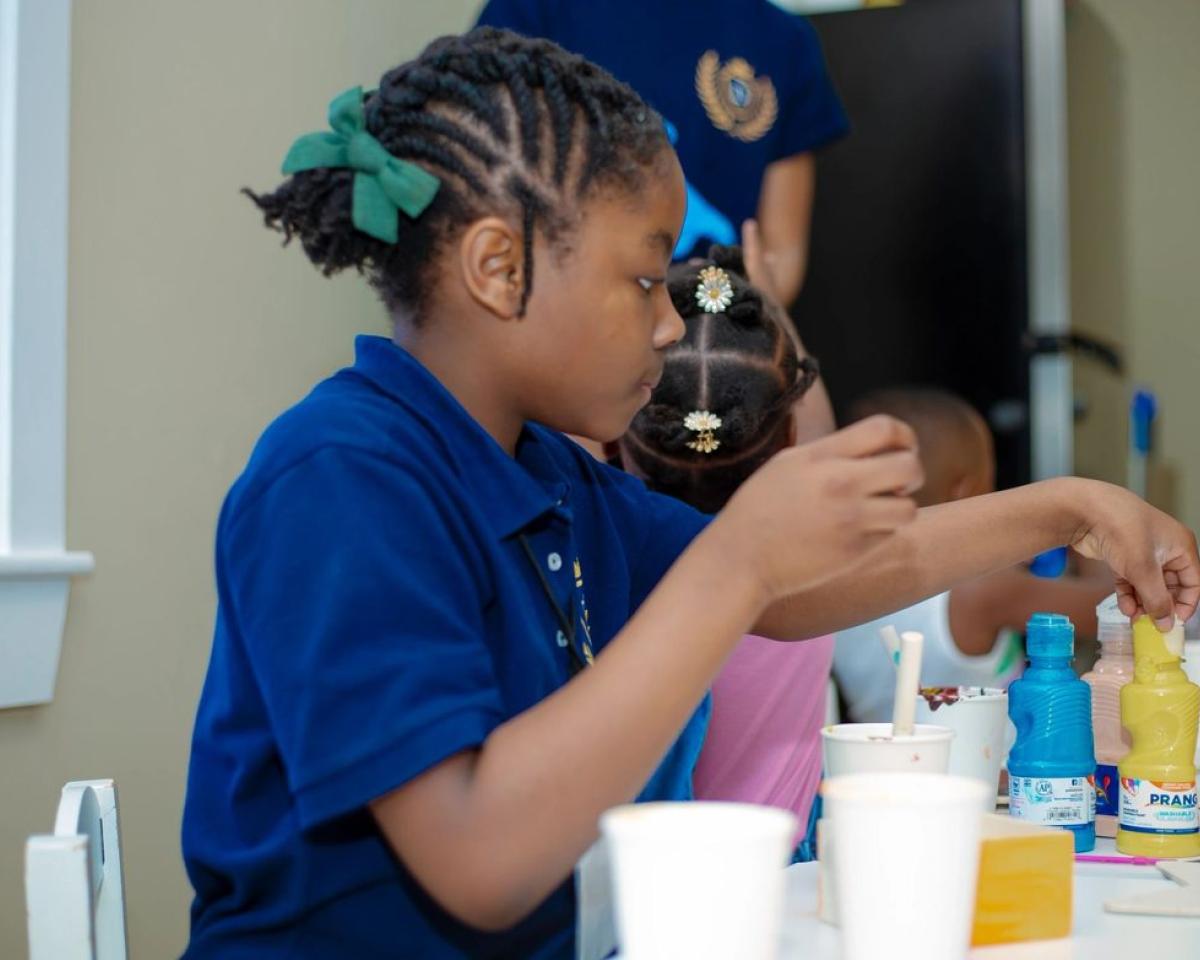 A girl carefully completing a structured table activity