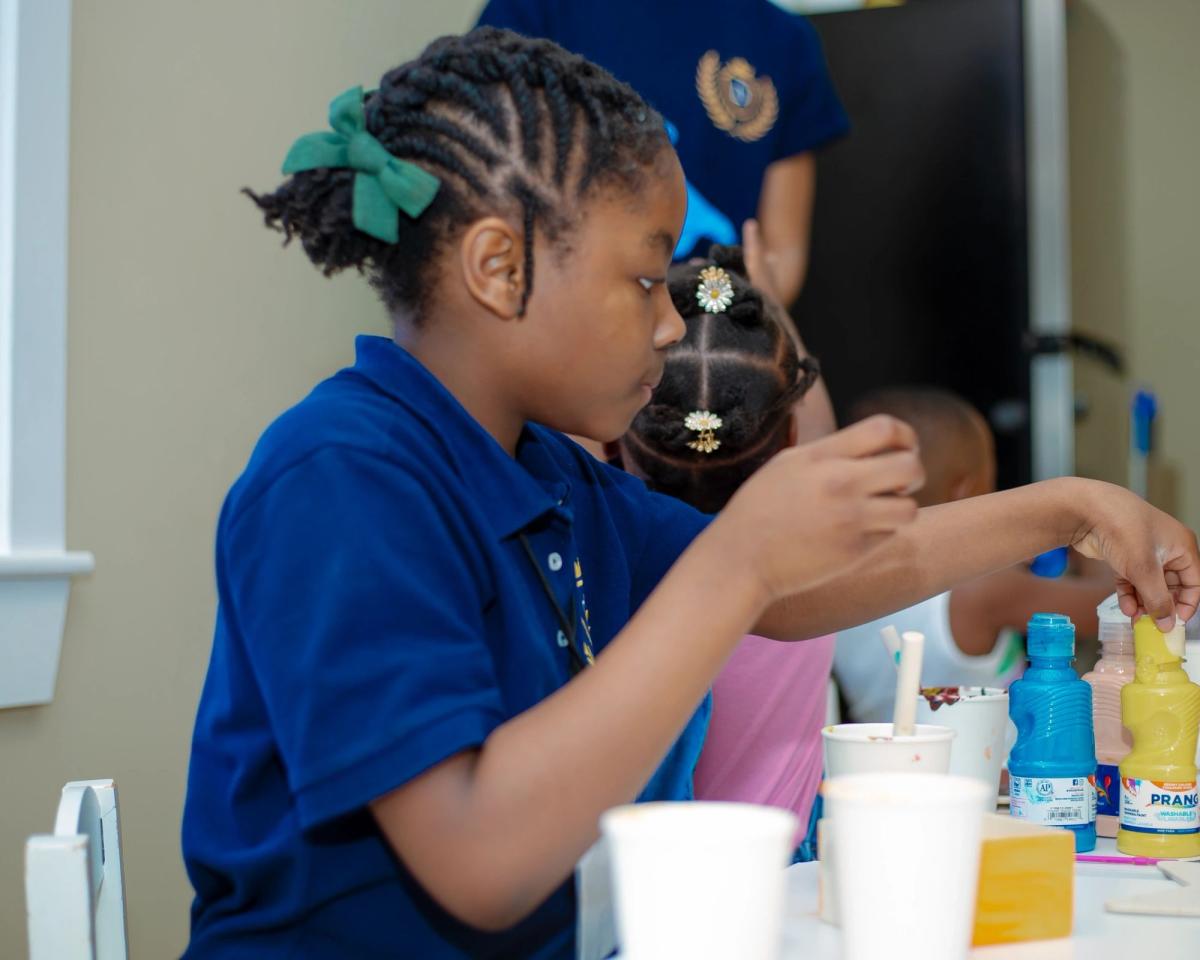 A child choosing paints in the classroom