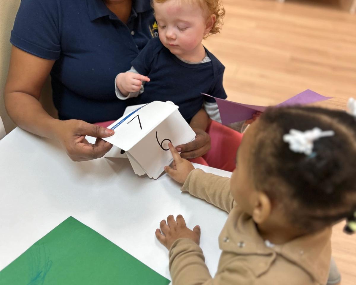A teacher learning with toddlers at La Distinction Academy